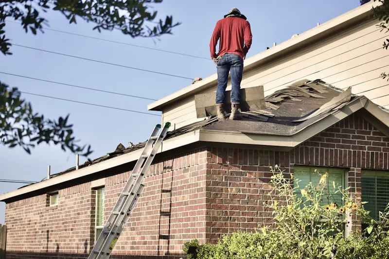 Professional roofer working on a residential roof in Boxford Station